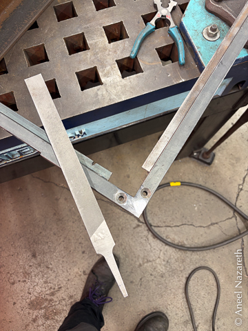 A shiny, smooth corner of the frame with a bastard file on top